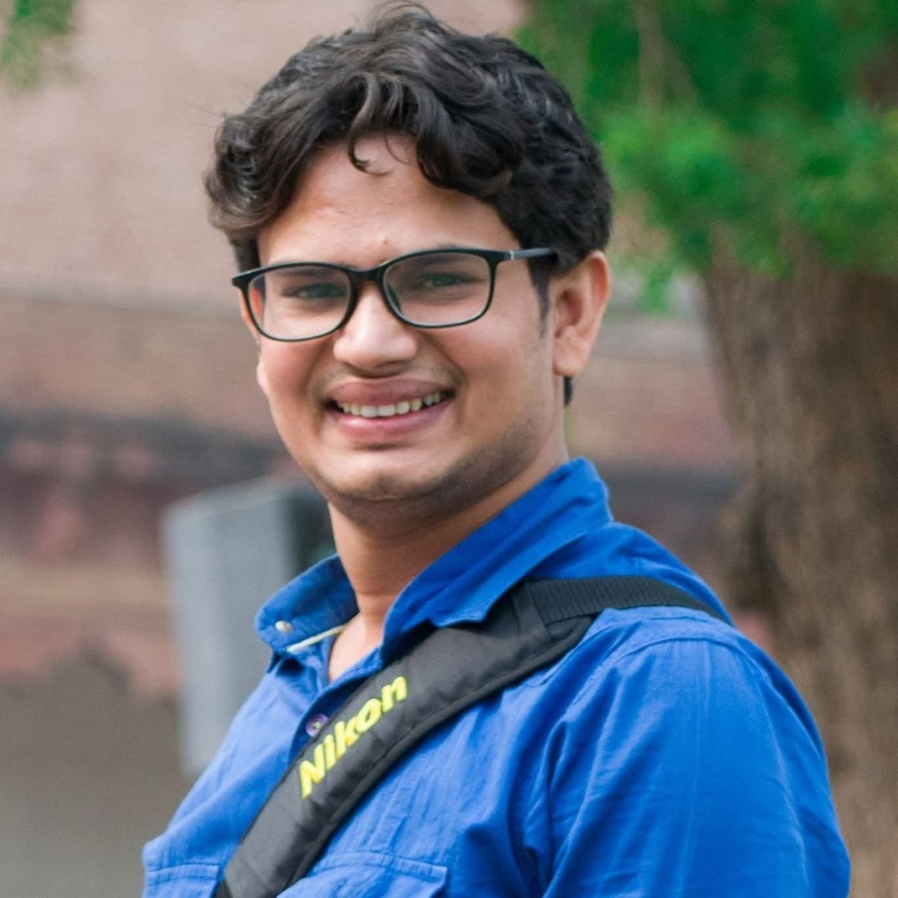 Shakti Tiwari — Nifty options trader, wearing blue shirt with camera